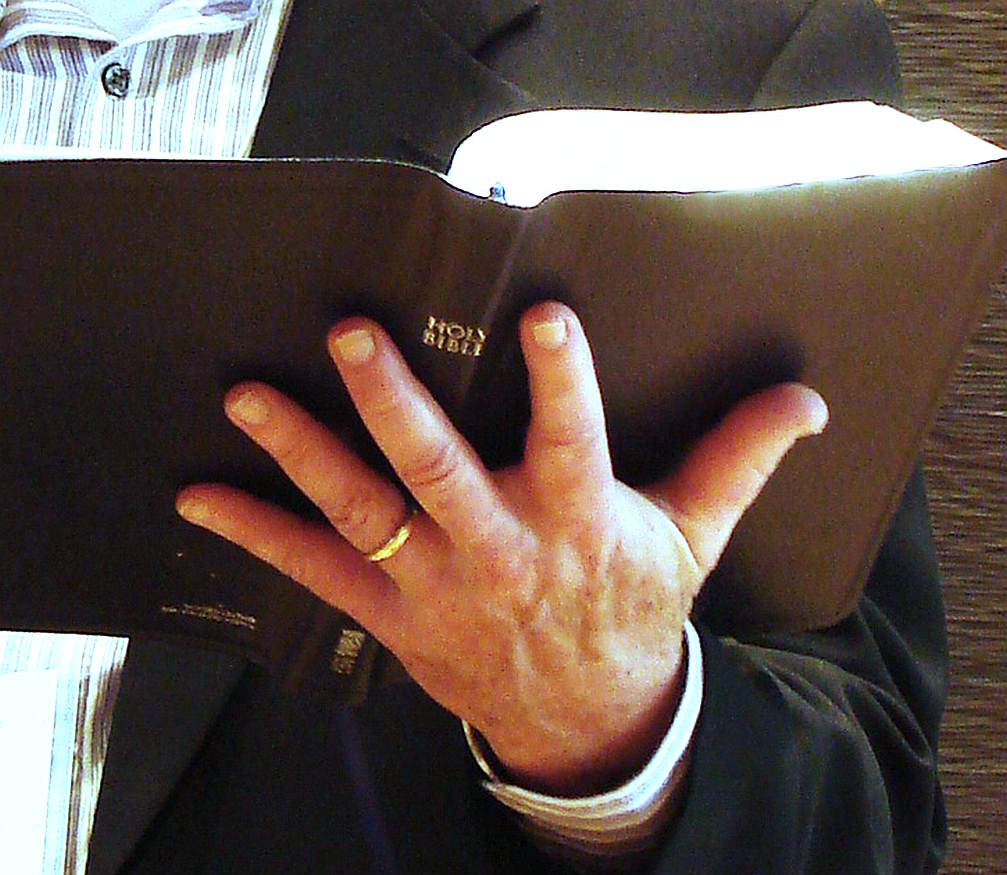Hand holding Bible